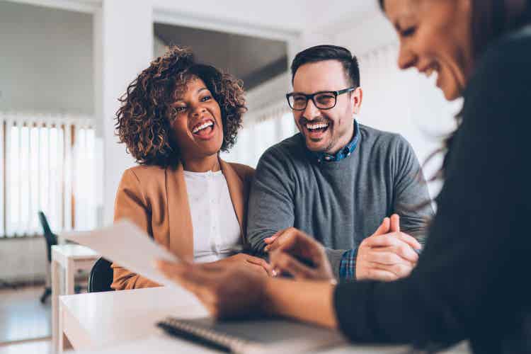 Two people smiling while learning about new financial services